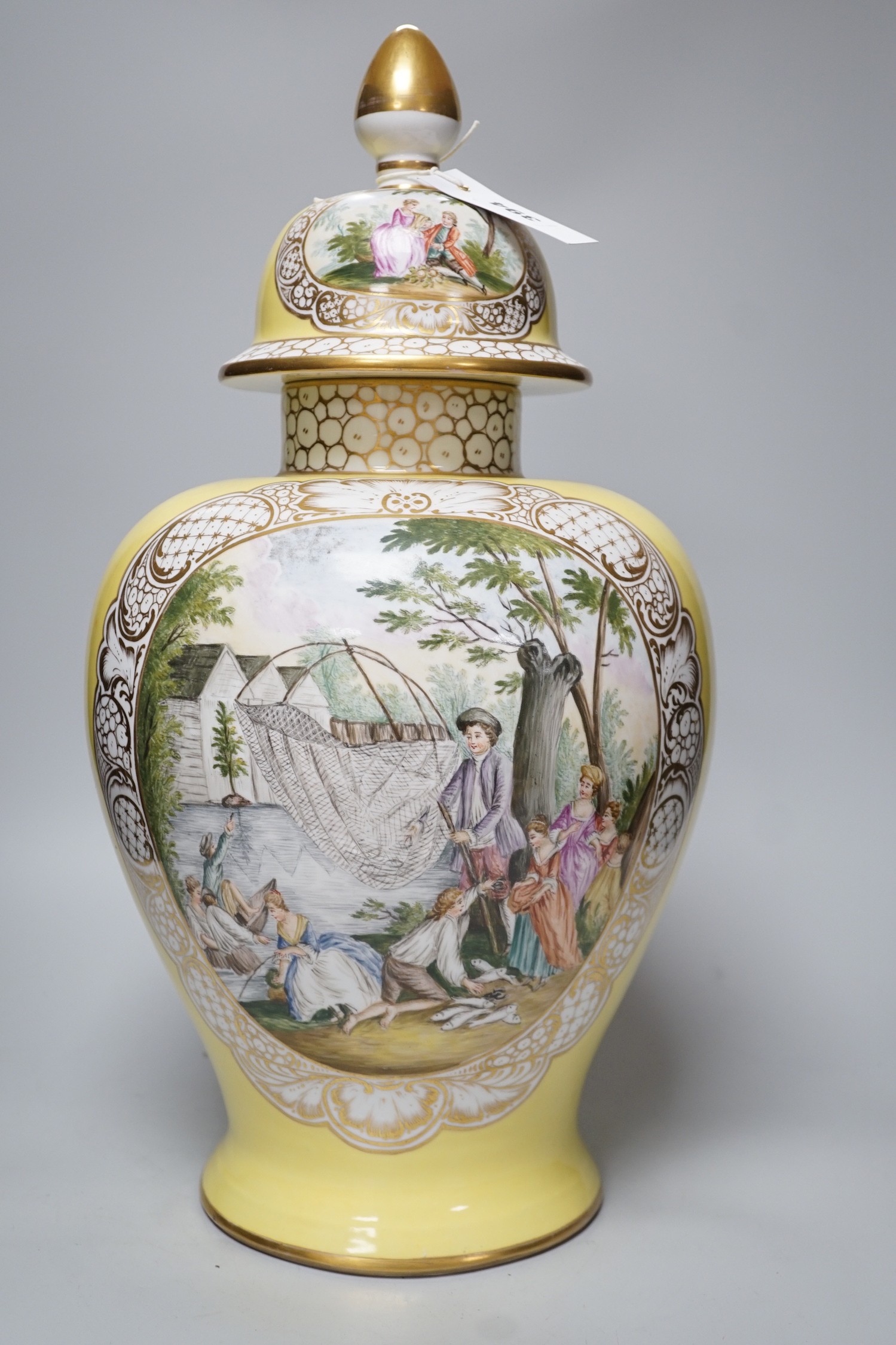 A large Helena Wolfsohn, Dresden vase and cover, from 1880, with a painted figural fishing cartouche one side and leisure activities the other, 52cms high